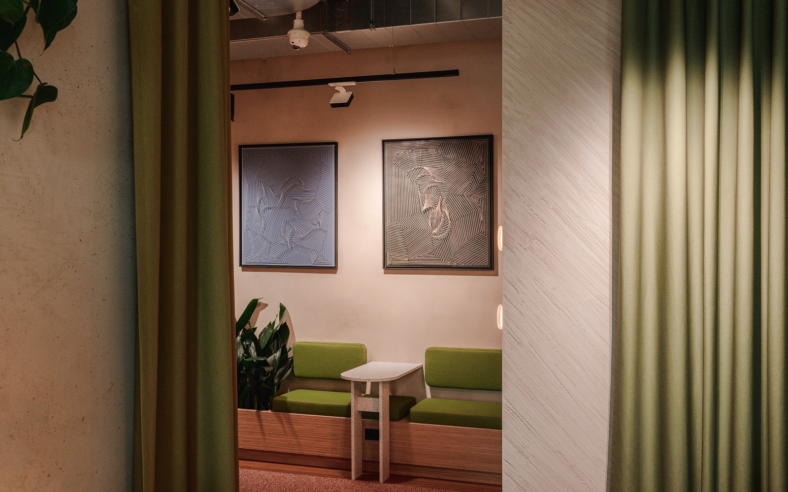 hotel lobby with art work above green banquette