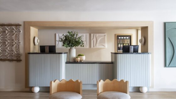 two chairs in front of reception desk at Hotel Avante by BHDM Design
