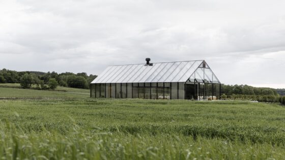 reflective exterior of restaurant in a field of grass