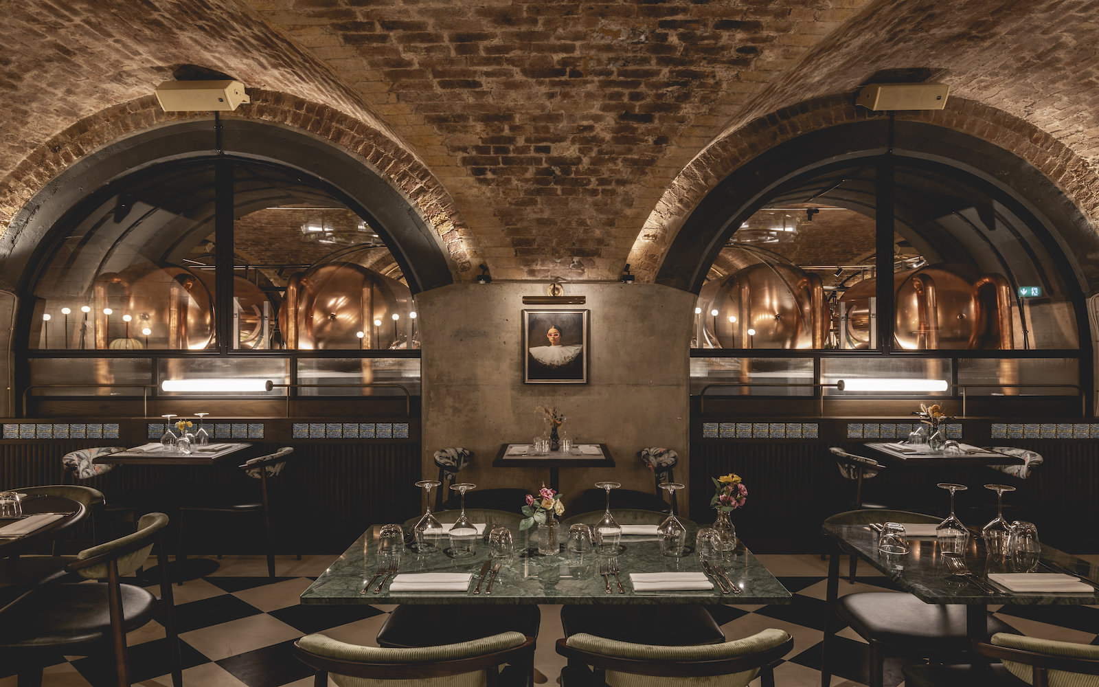 A dark lit restaurant sheltered in brick-walled building
